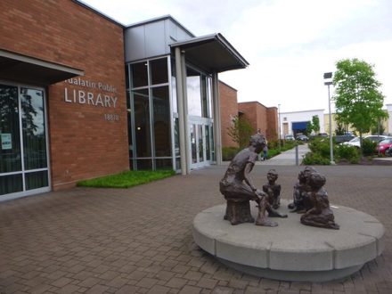 Tualatin Public Library - brick surface - parking lot - sidewalk to trailhead - shopping mall - statuary